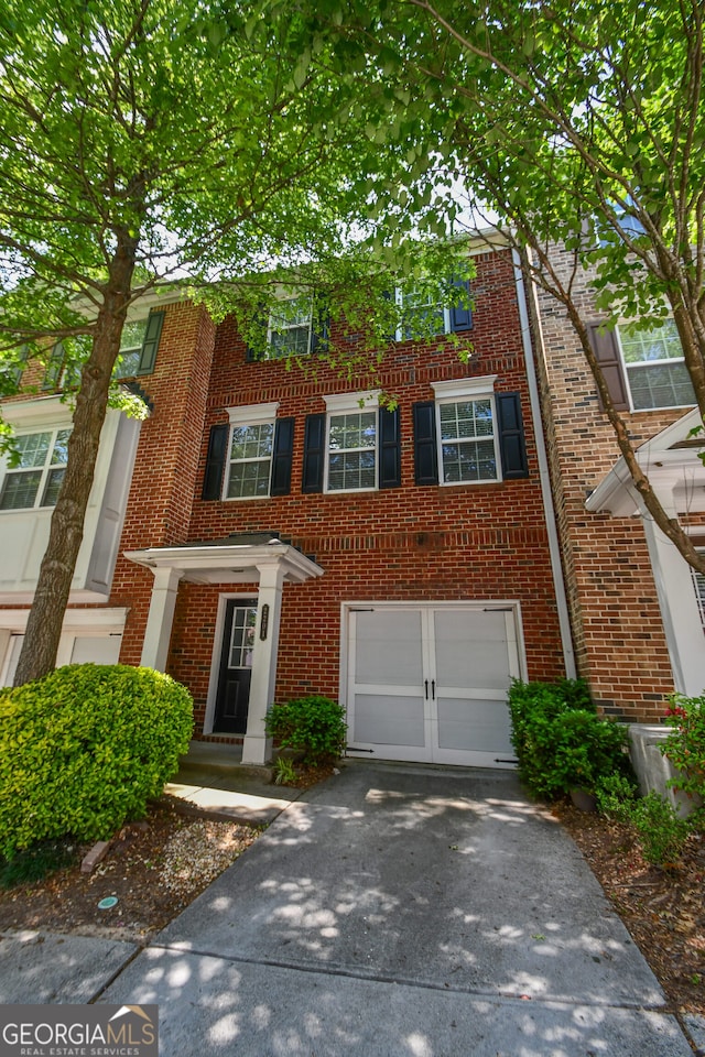 2201 Landing Walk Dr, Duluth, GA 30097 - multi unit property with brick siding, driveway, and a garage