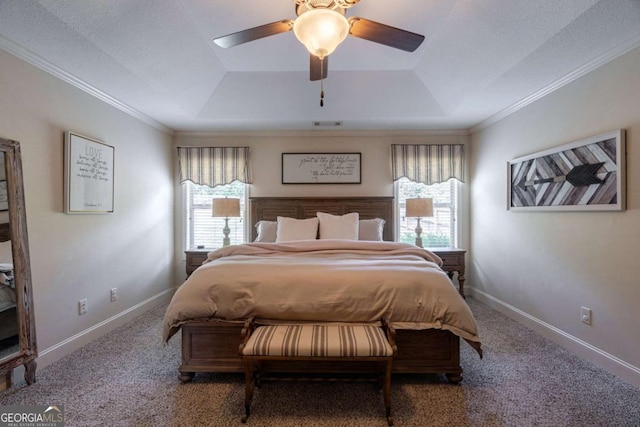 bedroom with carpet floors, multiple windows, and a raised ceiling