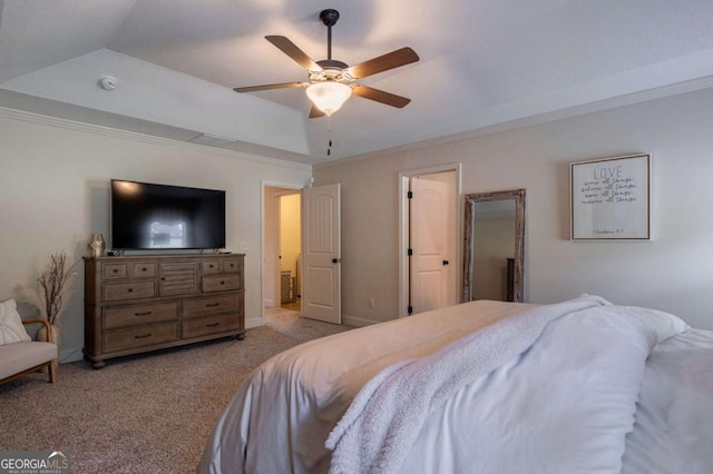 carpeted bedroom featuring crown molding, a raised ceiling, and a ceiling fan