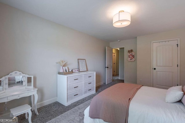 carpeted bedroom featuring baseboards