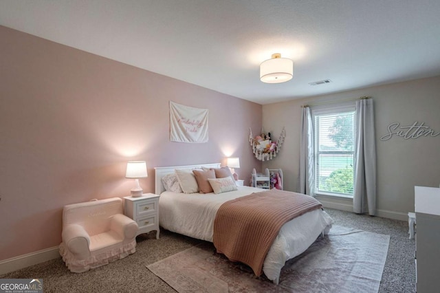 bedroom featuring visible vents, baseboards, and light colored carpet