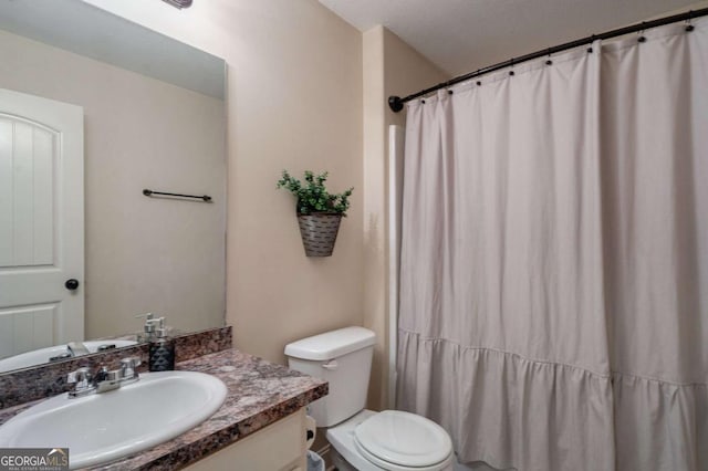 full bathroom with vanity, curtained shower, and toilet