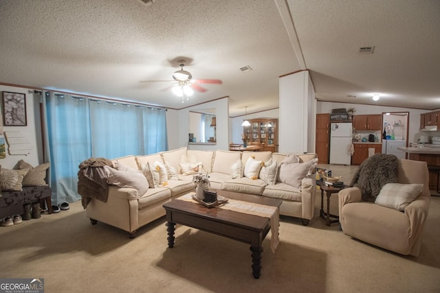 657 Reynolds Rd, Folkston, GA 31537 - living area featuring ceiling fan, light colored carpet, a textured ceiling, vaulted ceiling, and visible vents