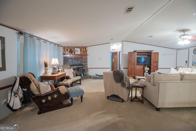 657 Reynolds Rd, Folkston, GA 31537 - living area with visible vents, a stone fireplace, light colored carpet, a textured ceiling, and a ceiling fan