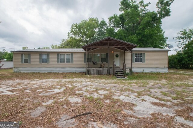 657 Reynolds Rd, Folkston, GA 31537 - manufactured / mobile home featuring a porch and metal roof