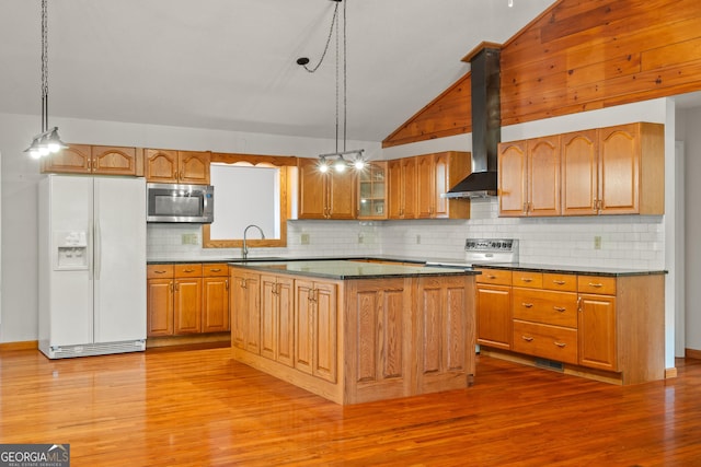 2421 Settlers Ridge Rd, Hiawassee, GA 30546 - kitchen with white fridge with ice dispenser, stainless steel microwave, lofted ceiling, light wood-style floors, and backsplash