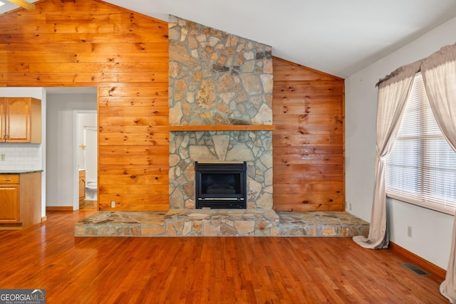 2421 Settlers Ridge Rd, Hiawassee, GA 30546 - unfurnished living room with lofted ceiling, wood finished floors, wooden walls, and a fireplace