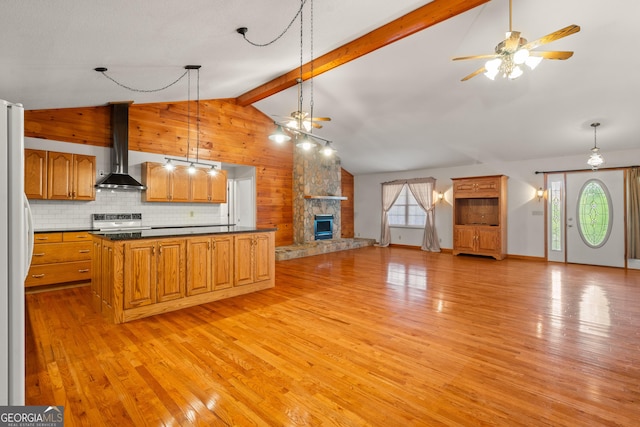 2421 Settlers Ridge Rd, Hiawassee, GA 30546 - kitchen featuring wall chimney exhaust hood, dark countertops, open floor plan, light wood-type flooring, and wooden walls