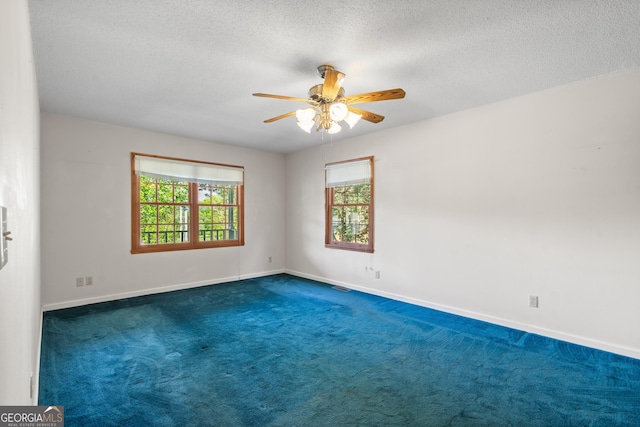 2421 Settlers Ridge Rd, Hiawassee, GA 30546 - spare room featuring dark colored carpet, ceiling fan, and a textured ceiling