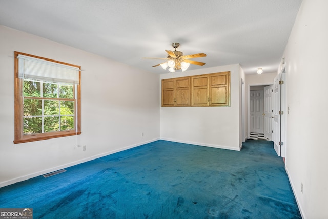 2421 Settlers Ridge Rd, Hiawassee, GA 30546 - unfurnished room with dark carpet and ceiling fan