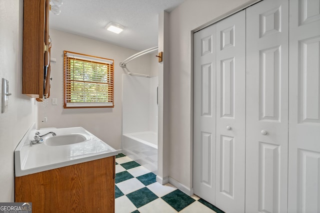 2421 Settlers Ridge Rd, Hiawassee, GA 30546 - full bathroom featuring a closet, tile patterned floors, vanity, bathtub / shower combination, and a textured ceiling