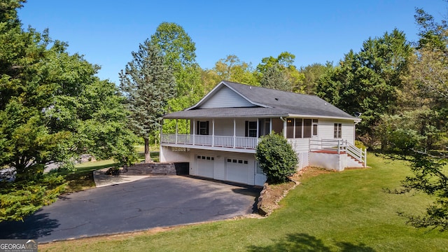 2421 Settlers Ridge Rd, Hiawassee, GA 30546 - view of front facade with asphalt driveway, a garage, and a front yard