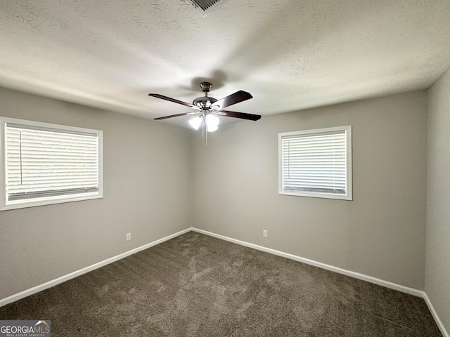 6507 Jackie Ln, Austell, GA 30106 - unfurnished room with a textured ceiling, dark colored carpet, a ceiling fan, baseboards, and visible vents