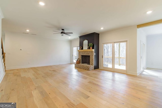 unfurnished living room with a fireplace, baseboards, light wood-type flooring, recessed lighting, and a ceiling fan