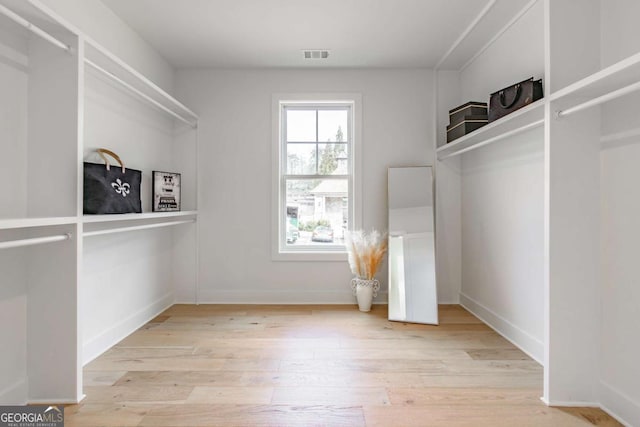 spacious closet featuring visible vents and wood finished floors