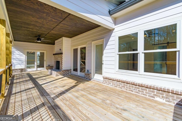 wooden terrace with a ceiling fan