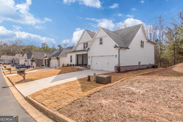 view of front of home featuring a garage, driveway, and cooling unit