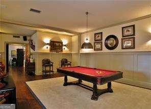 recreation room with billiards, a wainscoted wall, and a decorative wall