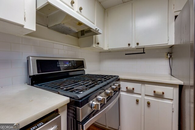 301 Lakemoore Dr NE Unit B, Atlanta, GA 30342 - kitchen with light countertops, white cabinetry, under cabinet range hood, tasteful backsplash, and stainless steel appliances