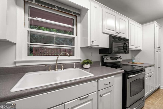 kitchen with white cabinets, electric range, dark countertops, black microwave, and a sink