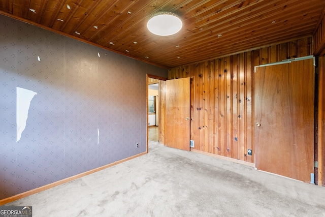 spare room featuring wooden ceiling and carpet
