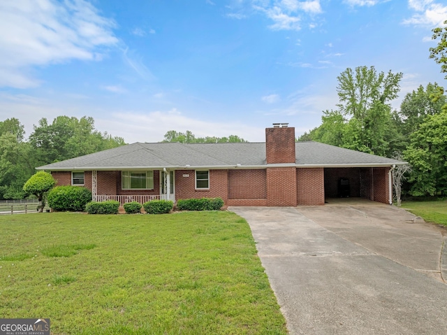 single story home with a porch, a front yard, a chimney, concrete driveway, and a carport