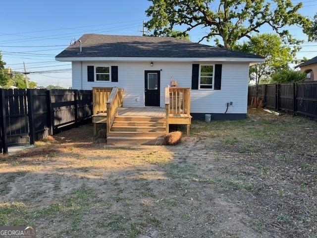 1823 Wrightsboro Rd, Augusta, GA 30904 - exterior space featuring a wooden deck, a fenced backyard, and roof with shingles