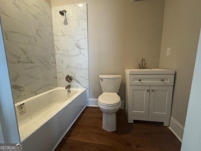 1823 Wrightsboro Rd, Augusta, GA 30904 - bathroom with shower / bathing tub combination, wood finished floors, baseboards, vanity, and toilet