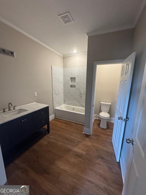 1823 Wrightsboro Rd, Augusta, GA 30904 - bathroom featuring crown molding, baseboards, toilet, and visible vents