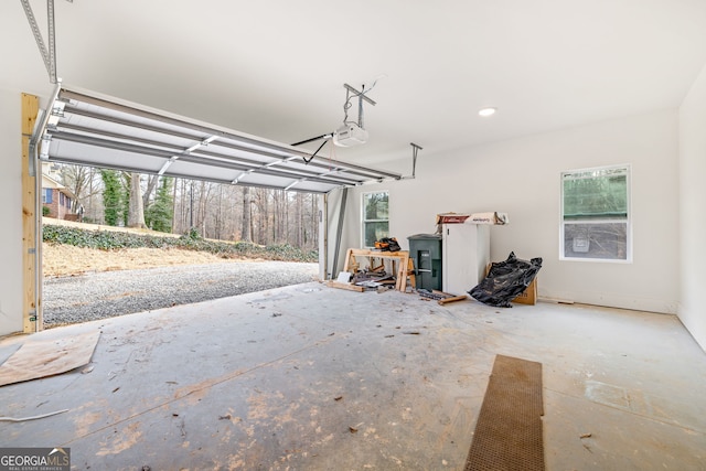 garage with recessed lighting and a garage door opener
