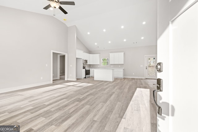 unfurnished living room featuring baseboards, light wood-style floors, ceiling fan, high vaulted ceiling, and recessed lighting