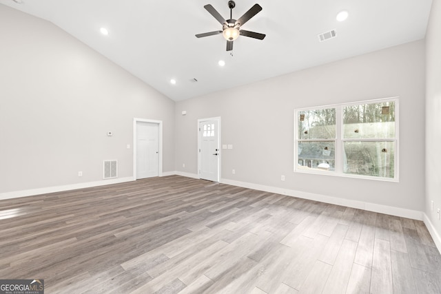 unfurnished living room featuring a wealth of natural light, ceiling fan, and visible vents