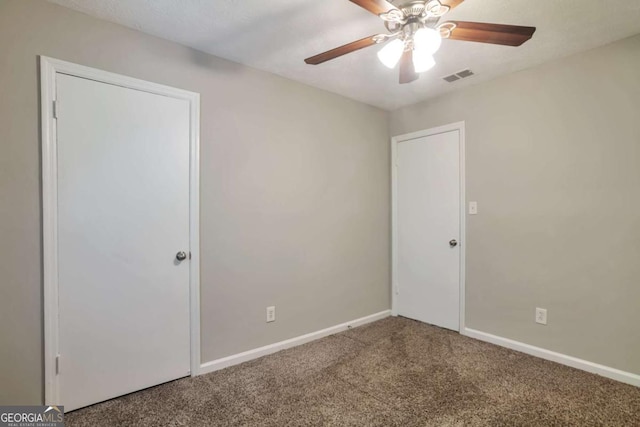 5379 Winslow Xing, Lithonia, GA 30038 - unfurnished bedroom with visible vents, baseboards, carpet floors, and ceiling fan