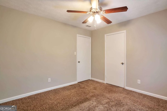 5379 Winslow Xing, Lithonia, GA 30038 - unfurnished bedroom featuring ceiling fan, carpet, baseboards, visible vents, and a closet