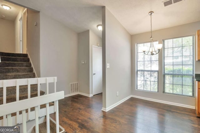 5379 Winslow Xing, Lithonia, GA 30038 - unfurnished dining area featuring visible vents, dark wood finished floors, stairway, baseboards, and a chandelier