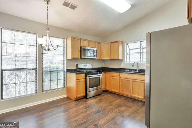 5379 Winslow Xing, Lithonia, GA 30038 - kitchen with visible vents, appliances with stainless steel finishes, a sink, lofted ceiling, and an inviting chandelier