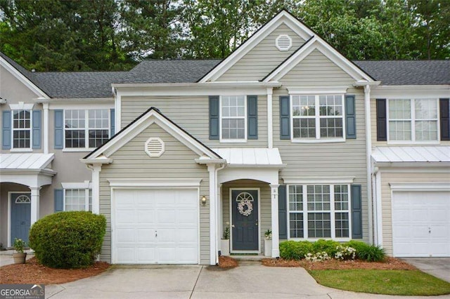 multi unit property with a garage and concrete driveway