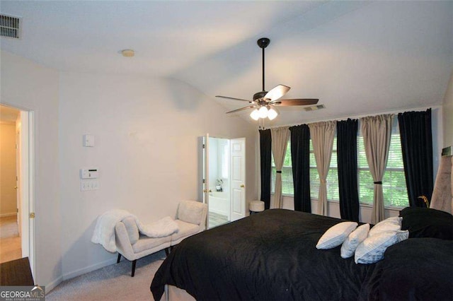 bedroom with light colored carpet, baseboards, visible vents, and vaulted ceiling