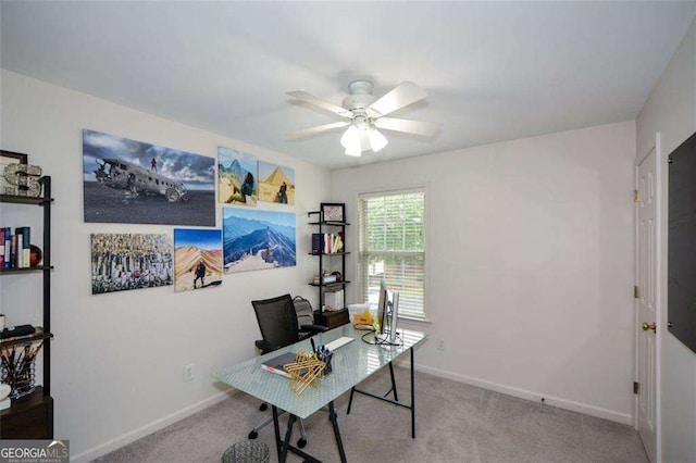 carpeted office with baseboards and ceiling fan
