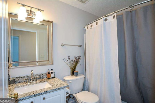 full bathroom featuring toilet, visible vents, and vanity
