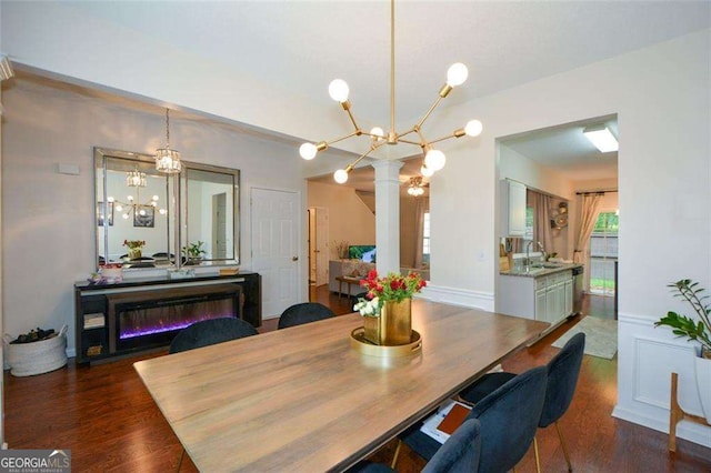 dining area featuring wood finished floors, a chandelier, and a wealth of natural light