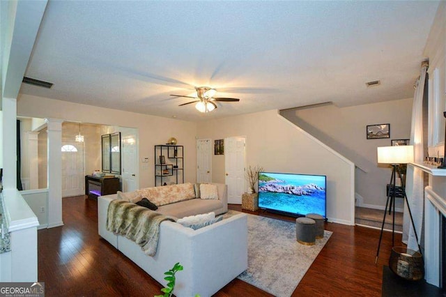 living room with baseboards, ceiling fan, wood finished floors, and visible vents