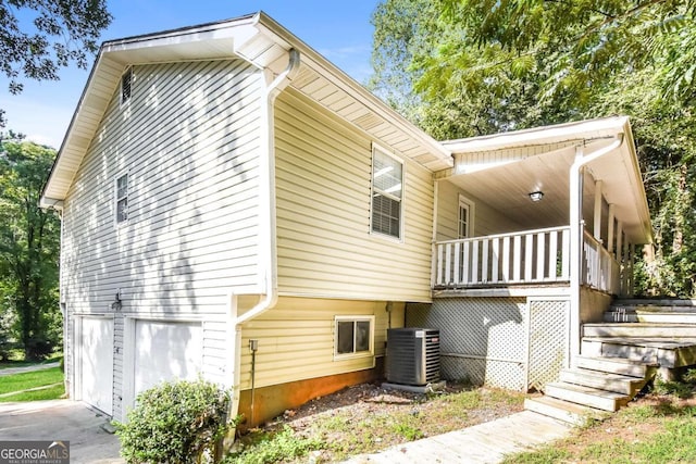 2636 Suzanne Ln, Acworth, GA 30102 - view of side of property featuring an attached garage, central air condition unit, stairs, and a porch