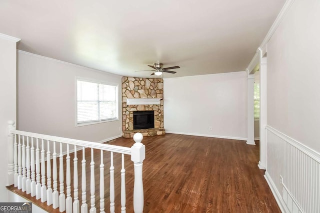 2636 Suzanne Ln, Acworth, GA 30102 - unfurnished living room featuring crown molding, ceiling fan, a fireplace, baseboards, and dark wood-type flooring