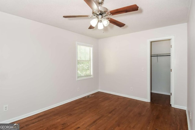 2636 Suzanne Ln, Acworth, GA 30102 - unfurnished bedroom featuring baseboards, a walk in closet, dark wood-style floors, and a closet
