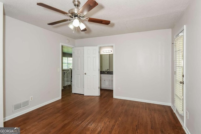 2636 Suzanne Ln, Acworth, GA 30102 - unfurnished bedroom with baseboards, dark wood finished floors, connected bathroom, and visible vents