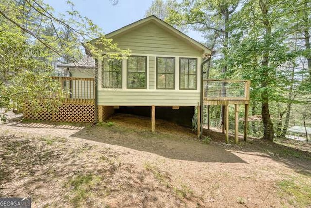 rear view of house featuring a deck and a sunroom