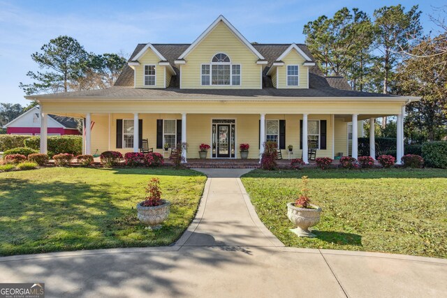 farmhouse featuring a porch and a front lawn