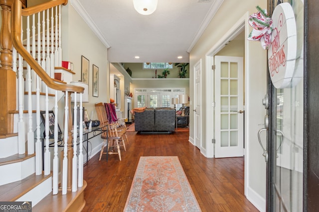 entrance foyer featuring crown molding, stairs, baseboards, hardwood / wood-style flooring, and french doors