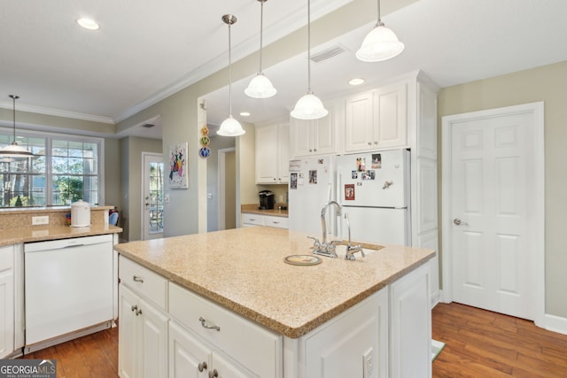 kitchen featuring pendant lighting, wood finished floors, white appliances, white cabinetry, and a sink